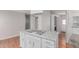 Updated kitchen island featuring granite countertops, an oven cooktop and white cabinets and trim at 2650 W Union Hills Dr # 269, Phoenix, AZ 85027