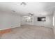 Large living room with built-ins, a ceiling fan, and expansive carpeting at 2650 W Union Hills Dr # 269, Phoenix, AZ 85027