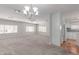 Bright living room featuring white trim, neutral walls and carpets and access to the kitchen at 2650 W Union Hills Dr # 269, Phoenix, AZ 85027