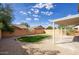 Landscaped backyard features a gravel yard, small lawn and covered patio at 2676 E Mineral Park Rd, San Tan Valley, AZ 85143