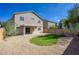 Spacious backyard featuring a covered patio, gravel yard, and lush lawn at 2676 E Mineral Park Rd, San Tan Valley, AZ 85143