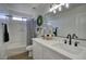 Bright bathroom with white cabinets, granite countertops, tub and modern fixtures at 2676 E Mineral Park Rd, San Tan Valley, AZ 85143