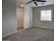 Cozy bedroom featuring carpet, sliding door closet and a ceiling fan at 2676 E Mineral Park Rd, San Tan Valley, AZ 85143