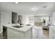 Bright kitchen featuring a center island with quartz countertops and an open layout that flows into the living area at 2676 E Mineral Park Rd, San Tan Valley, AZ 85143