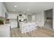 Modern kitchen featuring white cabinets, stainless steel appliances, quartz countertops, and a center island with seating at 2676 E Mineral Park Rd, San Tan Valley, AZ 85143