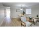 Bright living room with wood-look floors, neutral paint, and stylish seating, perfect for relaxation and entertaining at 2676 E Mineral Park Rd, San Tan Valley, AZ 85143