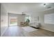 Bright, open living room with modern ceiling fan, wood flooring and sliding glass door to the yard at 2676 E Mineral Park Rd, San Tan Valley, AZ 85143
