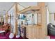A bar area with wood paneling, storage shelves and cabinets, and a built-in television at 2956 E Sequoia Dr, Phoenix, AZ 85050