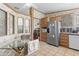 Eat-in kitchen with tile flooring, stainless steel refrigerator, and wooden cabinets at 2956 E Sequoia Dr, Phoenix, AZ 85050