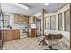 Kitchen featuring tile floors, wood cabinets, and an eat-in dining area at 2956 E Sequoia Dr, Phoenix, AZ 85050
