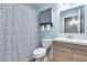 Modern bathroom featuring sleek vanity, decorative shower curtain, and cabinet for towels at 3178 W Williams Dr, Phoenix, AZ 85027