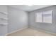 Bedroom featuring neutral walls, ceramic tile flooring, floating shelves, and a window with blinds at 3178 W Williams Dr, Phoenix, AZ 85027