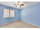 Bedroom featuring bright blue walls, ceramic tile flooring, and a window with blinds at 3178 W Williams Dr, Phoenix, AZ 85027