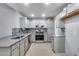 Well-lit kitchen features stainless steel appliances, stone countertops, and blue tile backsplash at 3178 W Williams Dr, Phoenix, AZ 85027