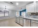 Open-concept kitchen with stainless steel appliances, stone countertops, and an eat-in kitchen at 3178 W Williams Dr, Phoenix, AZ 85027