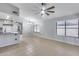 Open-concept living area with neutral colors, tile floors, and kitchen access at 3178 W Williams Dr, Phoenix, AZ 85027