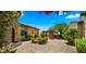 Expansive backyard with a fountain, fireplace, lush landscaping, and pavers, perfect for outdoor living at 36813 N 109Th Way, Scottsdale, AZ 85262