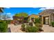 Inviting backyard patio featuring a fireplace, pergola, water feature, and desert landscaping at 36813 N 109Th Way, Scottsdale, AZ 85262