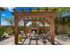 Outdoor living space with pergola, fireplace, pavers, and comfortable seating, ideal for entertaining at 36813 N 109Th Way, Scottsdale, AZ 85262