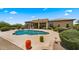 Inviting backyard pool area with water fountains, desert landscaping, and a covered patio in the background at 36813 N 109Th Way, Scottsdale, AZ 85262
