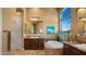 Bathroom featuring a soaking tub, granite countertops, dark wood cabinets, and a walk-in shower at 36813 N 109Th Way, Scottsdale, AZ 85262