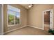 Bedroom with tan carpet, ceiling fan, and large window with natural light at 36813 N 109Th Way, Scottsdale, AZ 85262