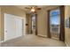 Bright bedroom featuring neutral carpet, a ceiling fan, and windows with pleated shades and draped side panels at 36813 N 109Th Way, Scottsdale, AZ 85262