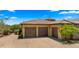 Spacious three-car garage with brown doors and a well-maintained driveway at 36813 N 109Th Way, Scottsdale, AZ 85262