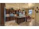 Beautiful kitchen with dark wood cabinets, stone floors, and stainless appliances at 36813 N 109Th Way, Scottsdale, AZ 85262