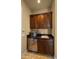 Cozy kitchenette featuring dark cabinetry, a compact refrigerator, and a sink for added convenience at 36813 N 109Th Way, Scottsdale, AZ 85262