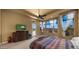 Spacious main bedroom with large windows, a ceiling fan, and TV sitting over a wooden dresser at 36813 N 109Th Way, Scottsdale, AZ 85262