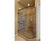Walk-in shower featuring decorative tile surround, glass enclosure, and built-in bench at 36813 N 109Th Way, Scottsdale, AZ 85262