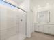 Bright bathroom showcasing a glass-enclosed shower and double sink vanity at 37168 W Prado St, Maricopa, AZ 85138