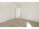 The neutral-toned carpeted bedroom has a closet and doorway to the hallway at 37168 W Prado St, Maricopa, AZ 85138