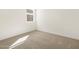 This bedroom has a window letting in natural light and plush neutral carpeting at 37168 W Prado St, Maricopa, AZ 85138