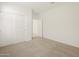This bedroom features neutral-toned carpeting and a sliding door closet at 37168 W Prado St, Maricopa, AZ 85138