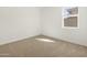 This bedroom has a window letting in natural light and plush neutral carpeting at 37168 W Prado St, Maricopa, AZ 85138