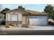 Charming single-story home with a two-car garage, stone accents, neutral colors, and desert landscaping at 37168 W Prado St, Maricopa, AZ 85138
