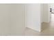 Bright hallway featuring neutral wall paint, leading to additional living spaces at 37168 W Prado St, Maricopa, AZ 85138