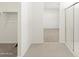 Hallway view including a walk-in closet and a glass shower at 37168 W Prado St, Maricopa, AZ 85138
