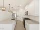 Modern kitchen with granite countertops, stainless steel appliances, and a large island at 37168 W Prado St, Maricopa, AZ 85138