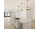 Bright, modern kitchen island with stainless steel sink and modern pendant lighting at 37168 W Prado St, Maricopa, AZ 85138