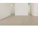 Spacious open-concept living area with neutral tile flooring and bright white walls at 37168 W Prado St, Maricopa, AZ 85138