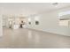 Open-concept living space with a kitchen island and lots of natural light at 37168 W Prado St, Maricopa, AZ 85138