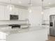 Beautiful kitchen with white cabinets, granite countertops, and stainless steel appliances at 37174 W La Paz St, Maricopa, AZ 85138
