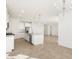 Open-concept kitchen featuring stainless steel appliances and a large island at 37174 W La Paz St, Maricopa, AZ 85138