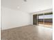 Living room with tile flooring, sliding glass doors, and a view of the backyard at 37174 W La Paz St, Maricopa, AZ 85138