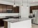 Close up of kitchen featuring granite countertops, stainless steel appliances, and island at 37198 W Vera Cruz Dr, Maricopa, AZ 85138