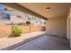 Covered back patio with gravel landscaping and block wall offering privacy and shade at 4010 W Fremont Rd, Phoenix, AZ 85041