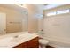 Bathroom with a single sink vanity and a shower-tub combo with white tile surround at 4010 W Fremont Rd, Phoenix, AZ 85041